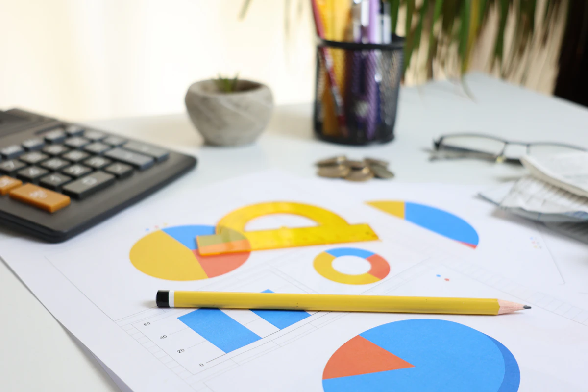 Calculator, charts and pencil on an accounting desk